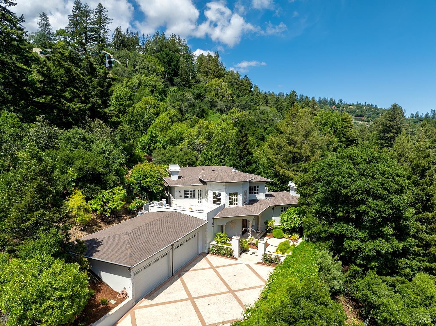 Aerial view of 2 Woodland Place, a French-inspired estate set among oaks on three private acres in Kent Woodlands, Marin County