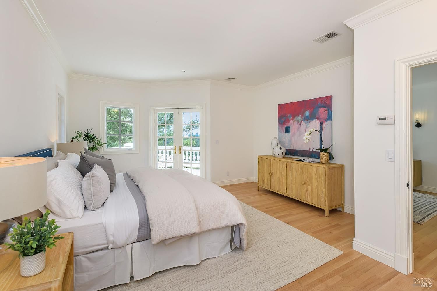 Primary bedroom with French doors to the garden balcony